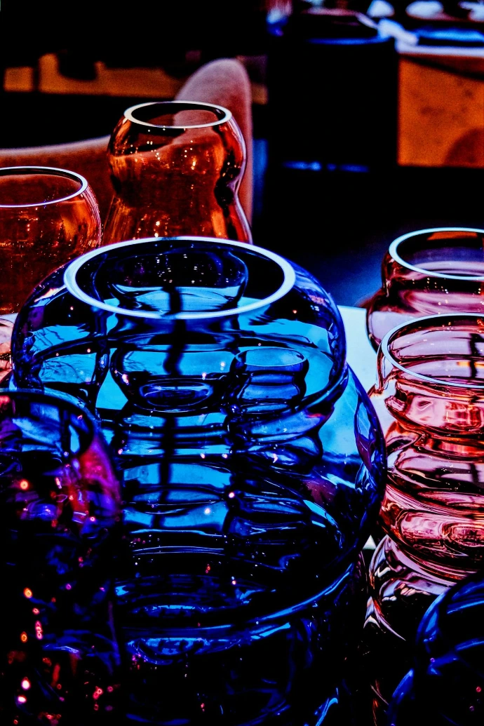 Close-up of colorful glass vases with reflections